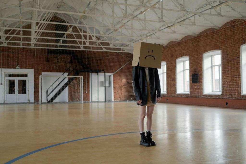 Girl with sad face box on her head